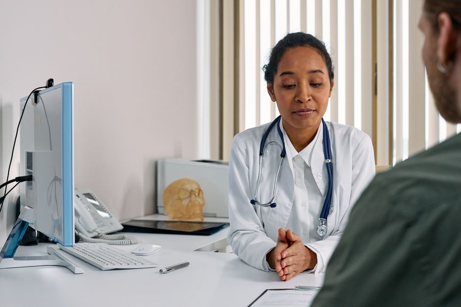A clinician consulting with a patient in a modern clinic
